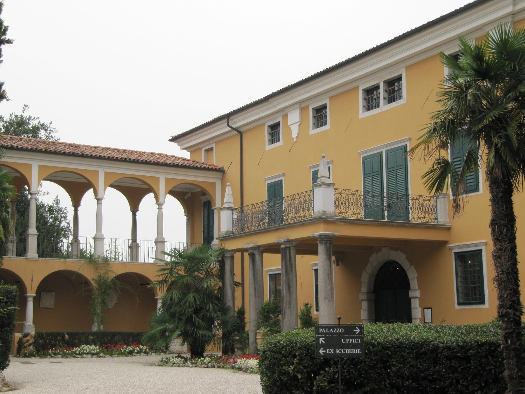 Yellow Palazzo Coronini Cronberg with its loggia and palm trees, Gorizia
