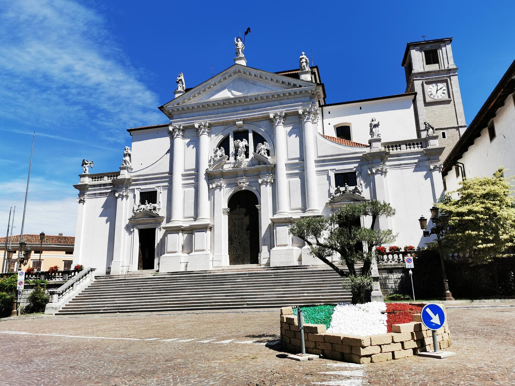 White Baroque cathedral and grand staircase on the main square of San Daniele